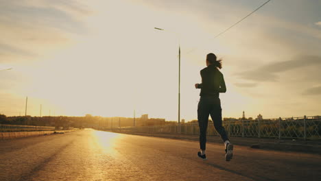 woman-is-running-in-morning-rear-view-of-sporty-lady-outdoors-in-sunset-or-sunrise-sport-and-active-lifestyle